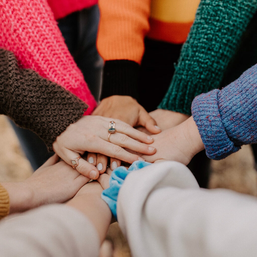 team stacking hands in a circle