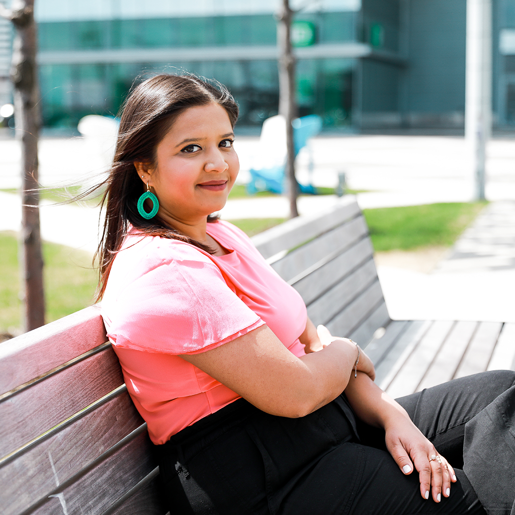 Nancy Thandi Di Nuzzo seated on a bench outdoors