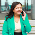 Nancy Thandi Di Nuzzo talking on the phone on a bench