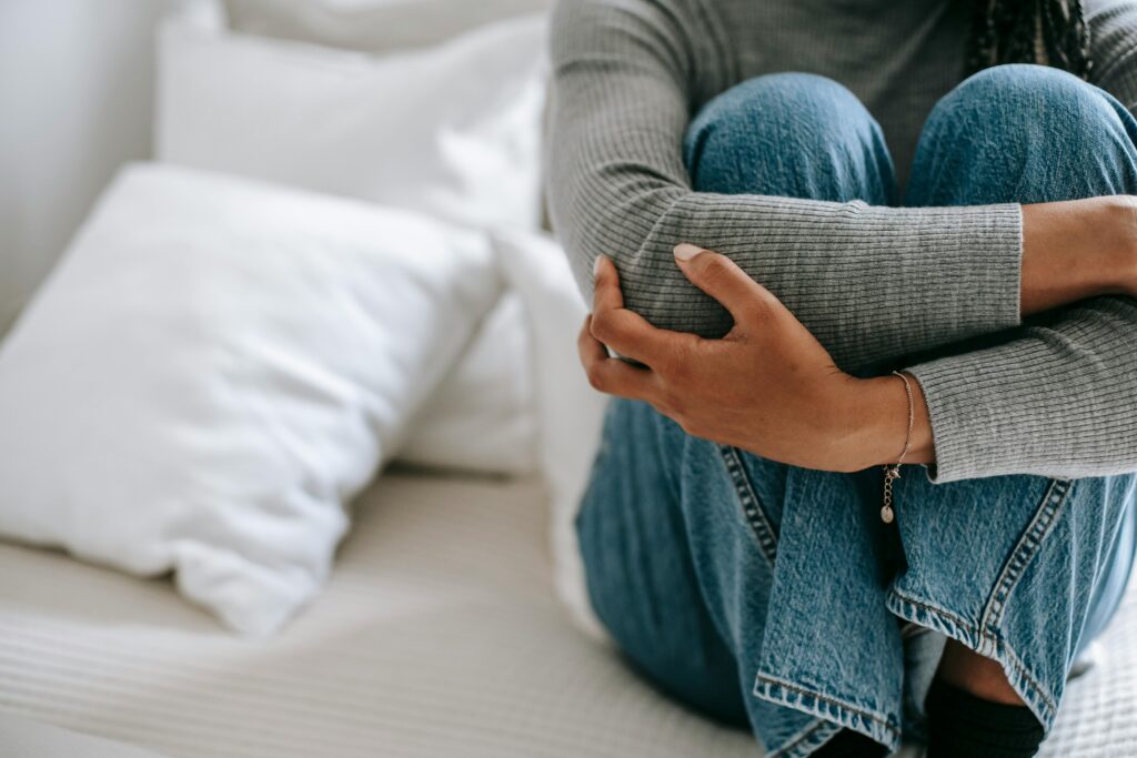 Woman sitting and cradling her knees