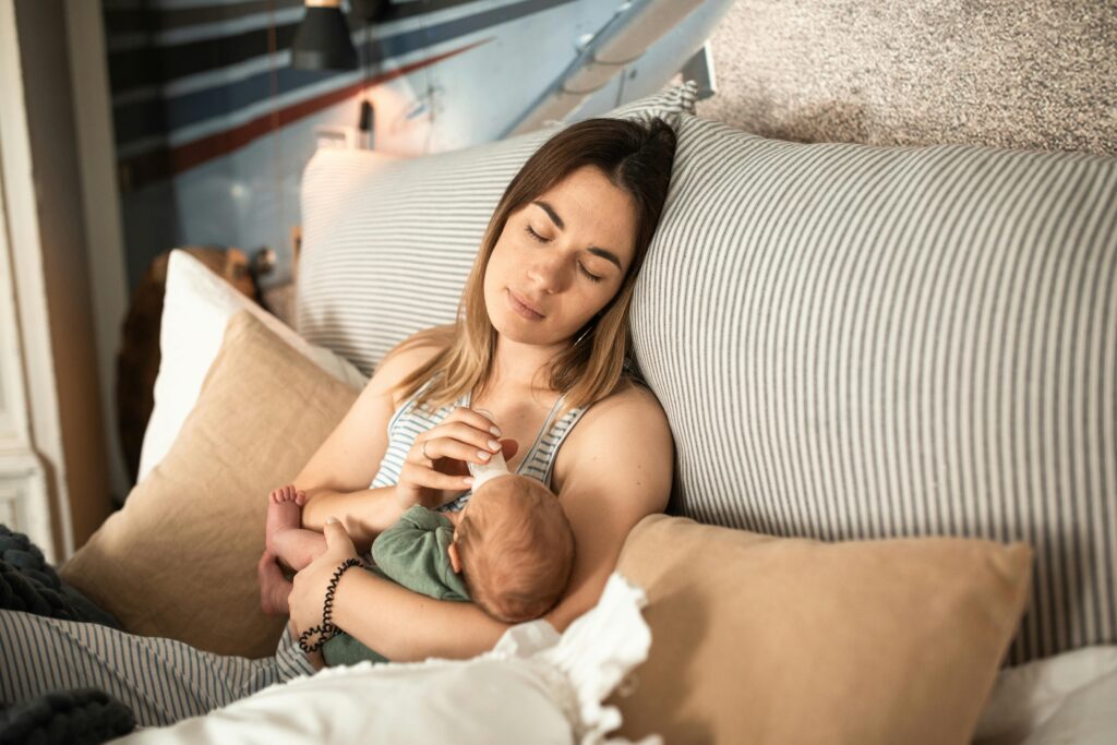Mother sleeping with baby in her arms